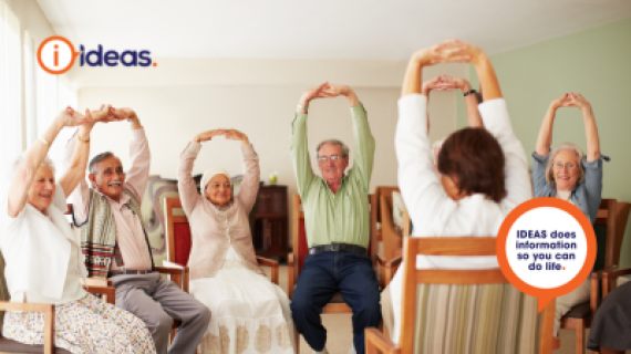 Group of elderly people in aged care sitining down, stretching their arms up