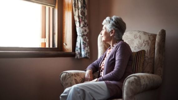 Elderly lady looking out a window