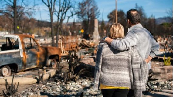A couple checking ruins after a fire disaster