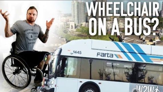 Man in a wheelchair holding his arms up