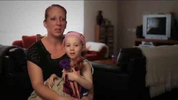 Mom with young daughter sitting on he lap