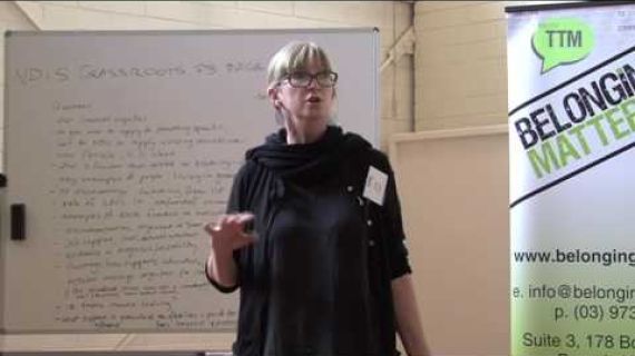 Lady standing in front of whiteboard speaking