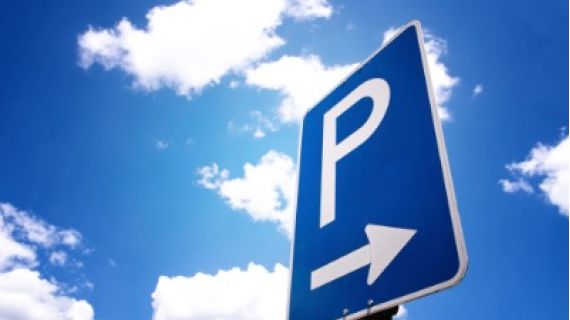 Blue sky with white clouds, a parking sign