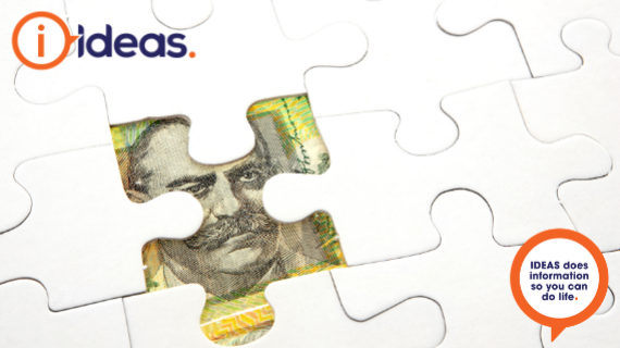 a put together puzzle with one piece missing. Under the piece missing is a part of an Australian note.