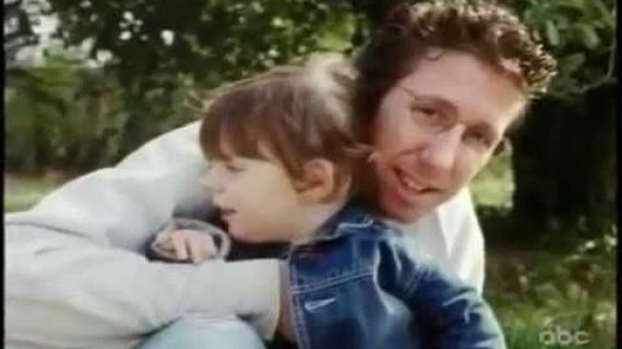Man hugging a young girl outside