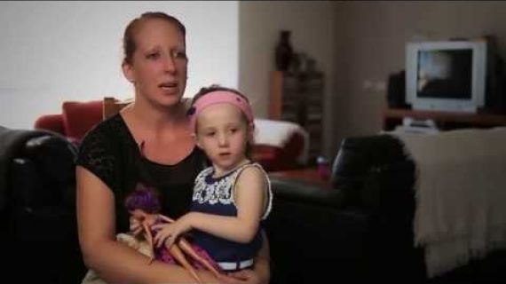 Mother with her daughter sitting on her lap