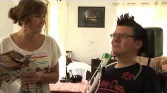 Man with a breathing device in a wheelchair