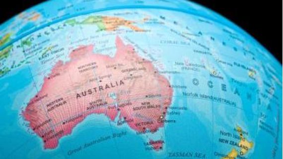 An image of a portion of a world globe showing a map of Australia in Pink