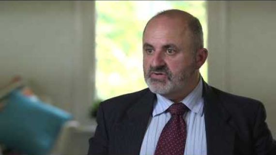 Man in a suit talking