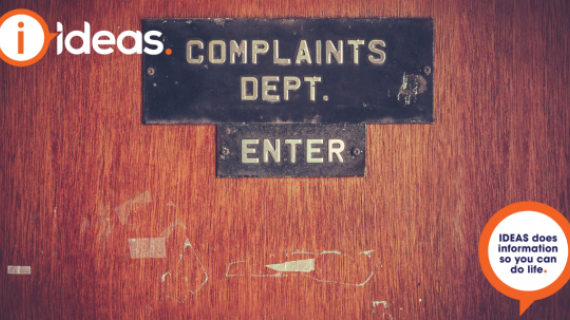 A close up of a door, with the words "Complains Dept, Enter"