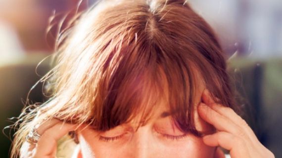 Close up of a woman rubbing her temples