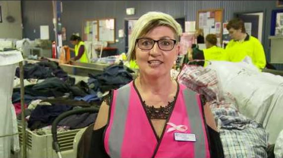 Lady in pink hi vis top in a factory
