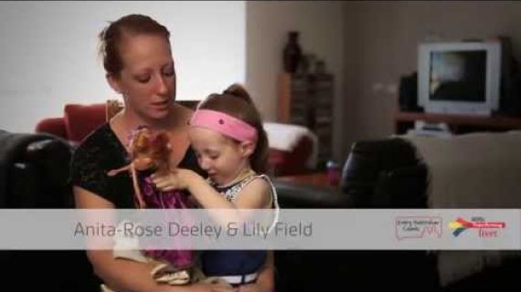 Mother with young daughter sitting on her lap