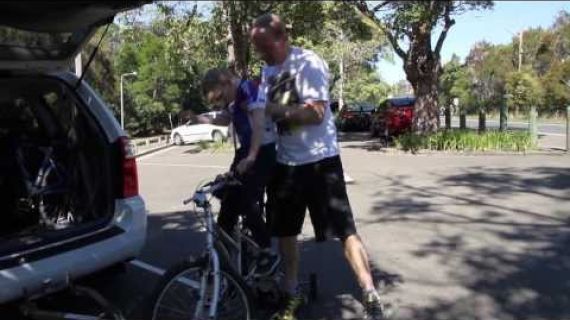 Man lifting his son off a bike