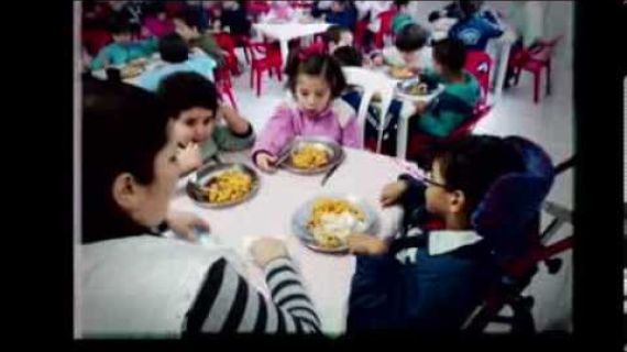Children sitting at a table eating