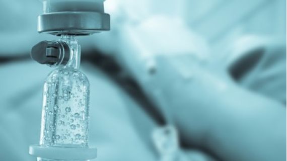 medical drip with patient in background