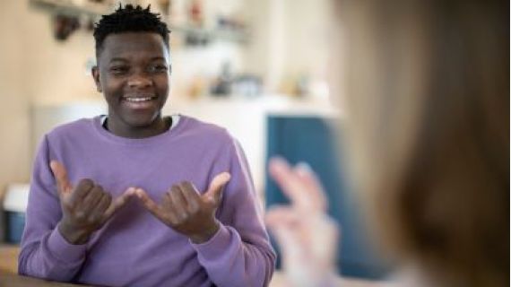 boy making a "W" symbol with his hands