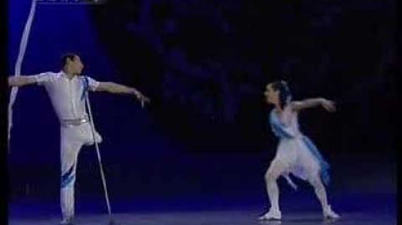 Man without a leg and woman without an arm on stage performing ballet