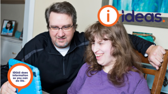 Two people, male and female, looking at a device.