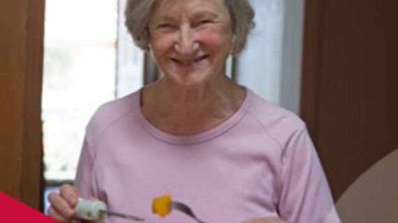 Lady eating a meal smiling