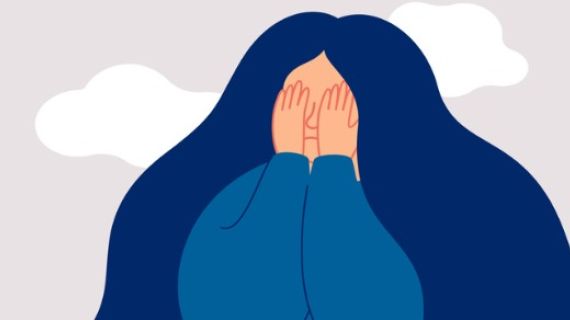 sad woman with hands over her eyes