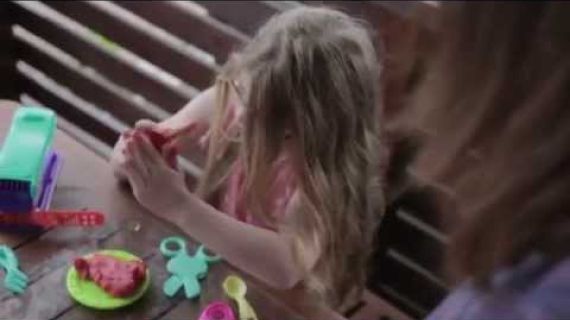 Young girl playing with toys at a table
