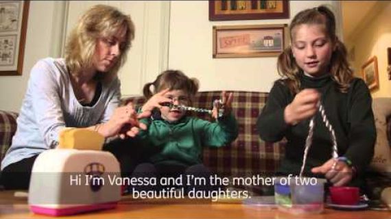 Mother sitting on the lounge playing with 2 daughters