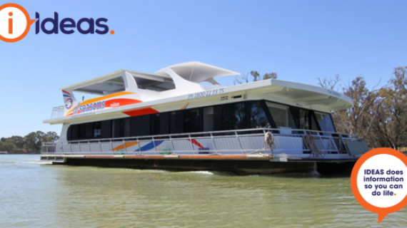 Image of a Houseboat on the water viewed from side on.