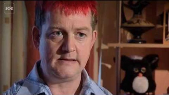 Man with red hair sitting and talking