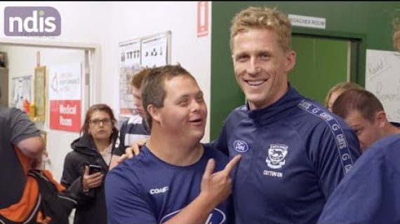 Picture of men in a football locker room chatting and laughing