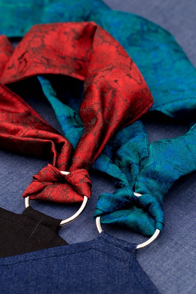 Close up of blue and red silks looped through blue and black denim