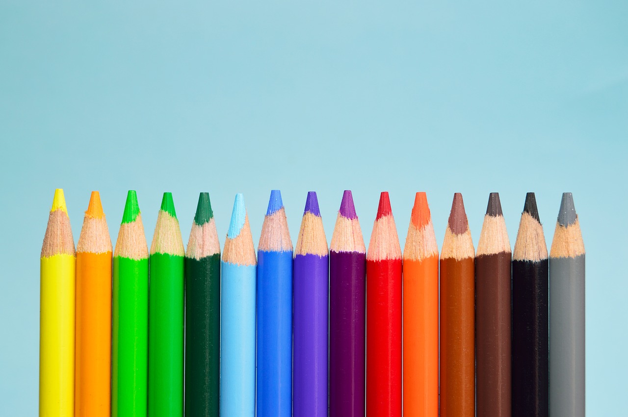 Row of coloured pencils going from yellow to grey